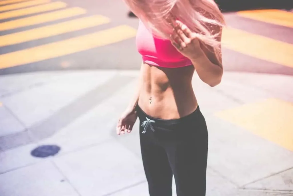Woman with toned stomach after LA-EMS Body Sculpting Treatment Harlow