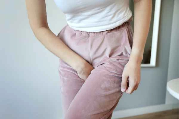 woman running for the toilet because of urinary incontinence Harlow